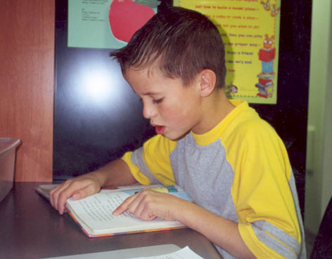 UURC student wearing yellow shirt reading